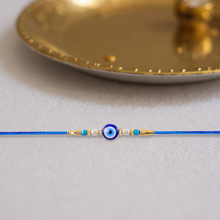 Stylish Blue Thread Rakhi With Central Stone Pearl Beads And Golden Detailing  Elegant Bracelet For Raksha Bandhan